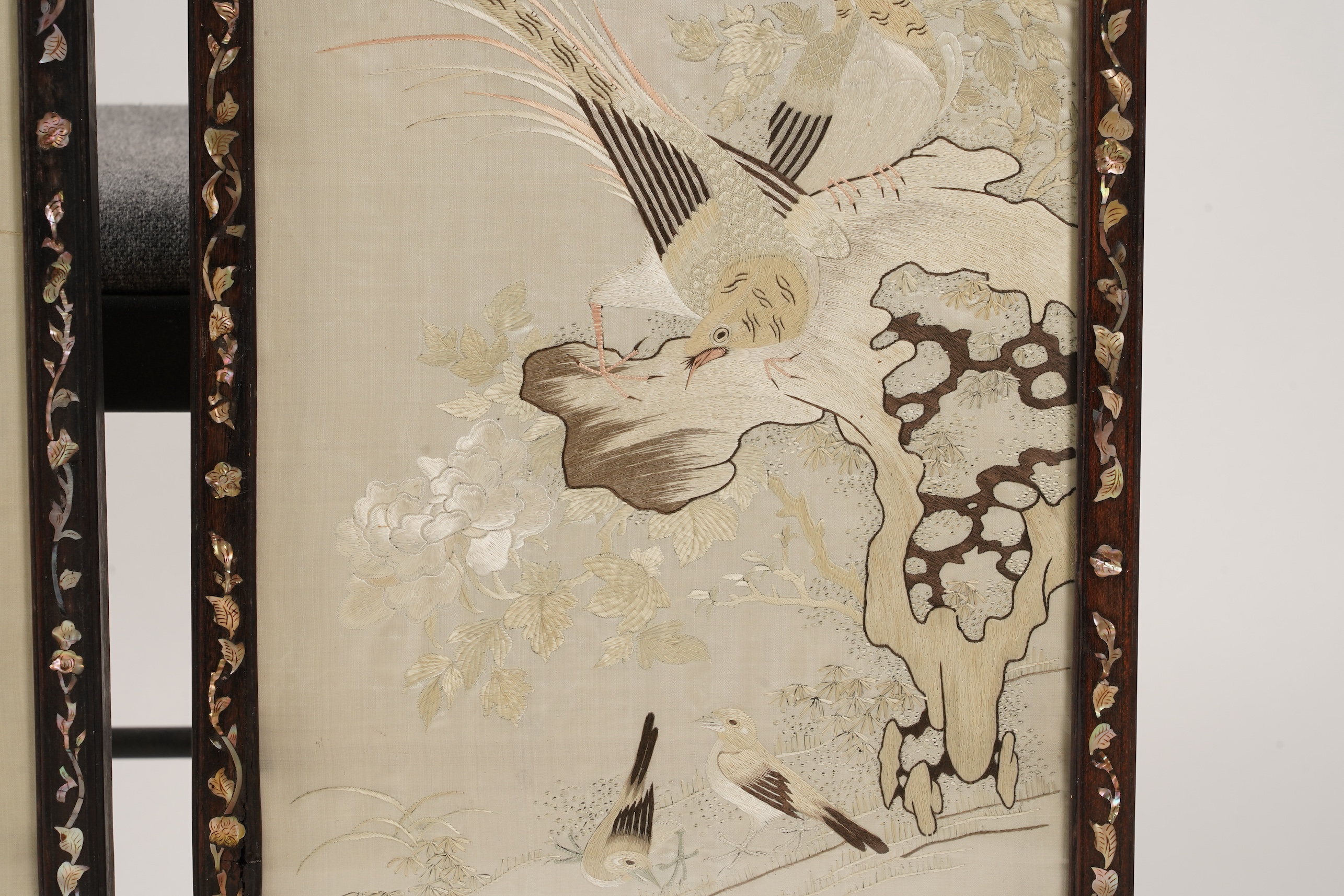 A pair of Chinese embroidered silk ‘bird’ panels, in mother-of-pearl inlaid hongmu frames, late 19th/early 20th century